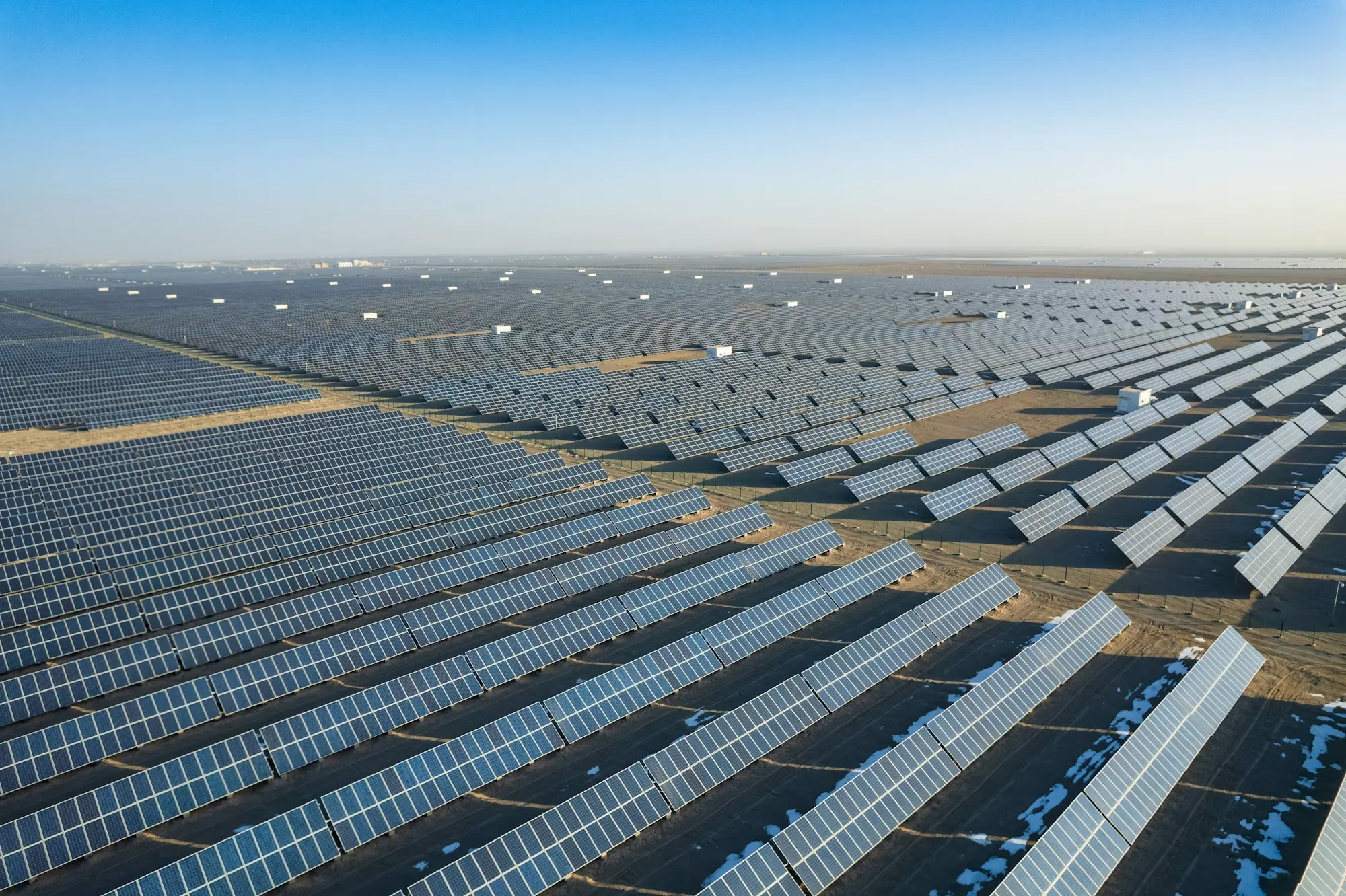 Aerial view of a utility-scale solar farm, in black and white